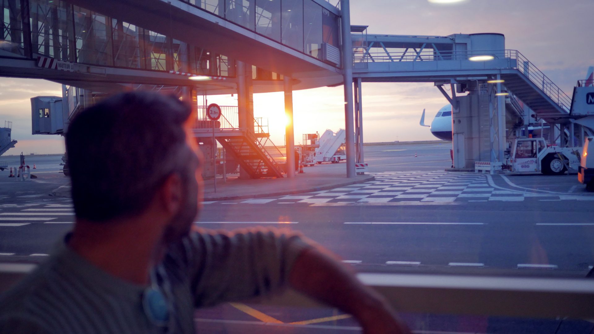 man looking the beautiful sunset at airport